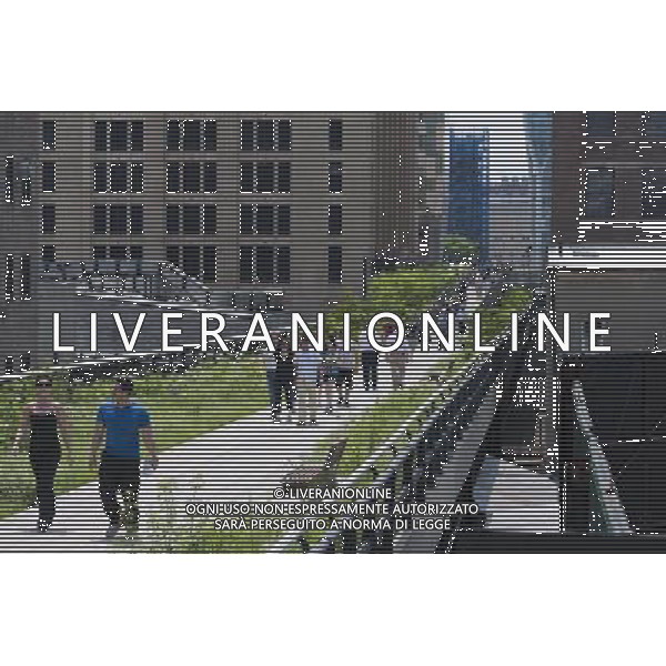 Opening day of the second phase, from West 20th Street to West 30th Street, of the High Line Park in Chelsea is seen on Tuesday, June 7, 2011. The new section includes a lawn for visitors to sit and sunbathe as well as a \'flyover\' walkway that raises you eight feet above the foliage. Since the first section opened millions of dollars in real estate has been developed along the park. (Œ© Richard B. Levine) /PHOTOSHOT/AG ALDO LIVERANI SAS - ITALY ONLY - *** Local Caption *** .