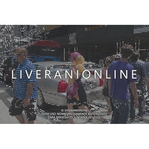 A women covers herself for protection from the sun as she crosses 42nd Street in Times Square in New York on Thursday, June 9, 2011. Today was the third day of over 90 degree weather in the city officially making it a heat wave. Temperatures are expected to mitigate overnight but scientists are predicting more of the same due to a global climate change. (Œ© Richard B. Levine) /PHOTOSHOT/AG ALDO LIVERANI SAS - ITALY ONLY - *** Local Caption *** .