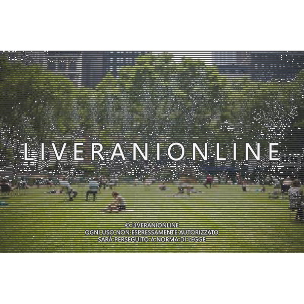 Park goers bake on the lawn of Bryant Park in New York on Thursday, June 9, 2011 as a sprinkler waters the grass. Today was the third day of over 90 degree weather in the city officially making it a heat wave. Temperatures are expected to mitigate overnight but scientists are predicting more of the same due to a global climate change. (å© Richard B. Levine) /PHOTOSHOT/AG ALDO LIVERANI SAS - ITALY ONLY - *** Local Caption *** .