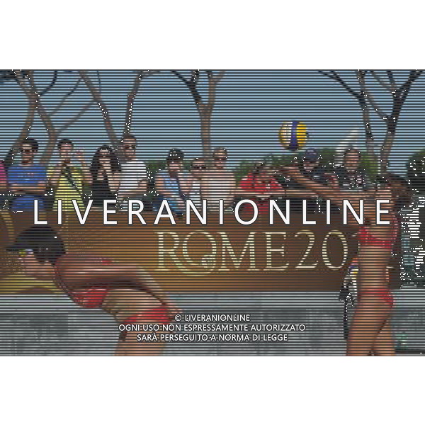 (110618) -- ROME, June 18, 2011 () -- Chinese player Xue Chen (R) serves the ball during the women\'s quarterfinal between China\'s pair Xue Chen/Zhang Xi and Brazil\'s Maria Antonelli/Talita Da Rocha Antunes at the 2011 FIVB Beach Volleyball World Championships in Rome, Italy, June 17, 2011. Xue Chen/Zhang Xi won 2-1 to enter the semifinal. (/Wang Qingqin) AG ALDO LIVERANI S A S ONLY ITALY