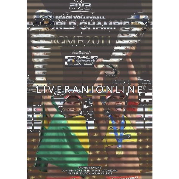 (110620) -- ROME, June 20, 2011 () -- Brazil\'s Larissa Franca(L)/Juliana Felisberta Da Silva hold their tropies at the awarding ceremony after winning the women\'s final against United States\' Misty May-Treanor/Kerri Walsh at the 2011 FIVB Beach Volleyball World Championships in Rome, Italy, June 19, 2011. Larissa/Juliana won 2-1 to claim the world title. (/Wang Qingqin) AG ALDO LIVERANI S A S ONLY ITALY