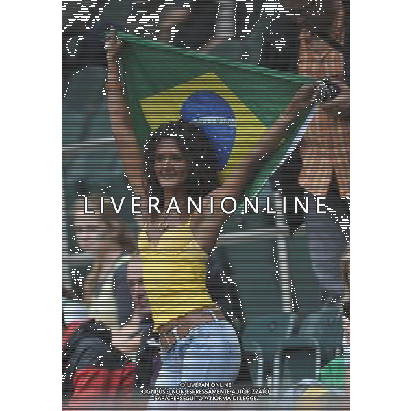 (110630) -- MONCHEGLADBACH, June 30, 2011 () -- A fan lifts national flag of Brazil during the first round Group D match between Brazil and Australia at the FIFA Women\'s World Cup Germany 2011 in Monchengladbach, Germany, June 29, 2011. Brazil won with 1-0. (/Wu Wei)