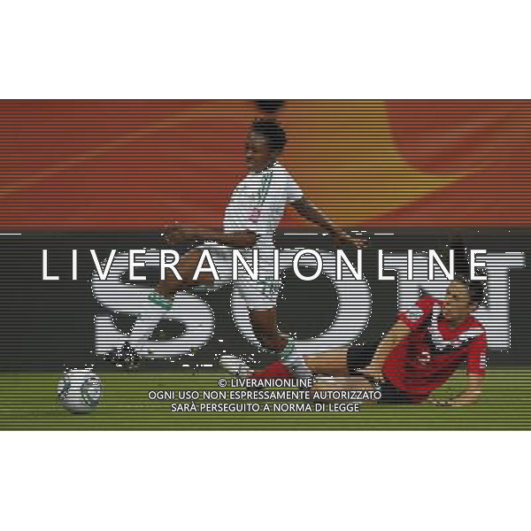 (110706) -- DRESDEN, July 6, 2011 () -- Nigeria\'s Stella Mbachu (L) fights with Canada\'s Emily Zurrer during their Group A third round match at the 2011 FIFA Women\'s World Cup at the Rudolf-Harbig-Stadion in Dresden, Germany, July 5, 2011. Nigeria won the match 1-0. Either team advanced to the next round. (/Ding Xu)