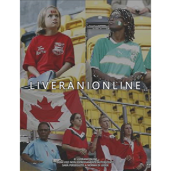 (110706) -- DRESDEN, July 6, 2011 () -- The combo picture shows Supporters react after the Group A third round match between Canada and Nigeria at the 2011 FIFA Women\'s World Cup at the Rudolf-Harbig-Stadion in Dresden, Germany, July 5, 2011. Nigeria won the match 1-0. (/Ding Xu)