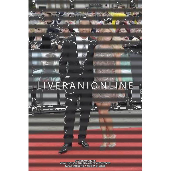 Theo Walcott (L) and Melanie Slade arrives at the World Premiere of \'Harry Potter And The Deathly Hallows Part 2\' in Trafalgar Square on July 7, 2011 in London, England.