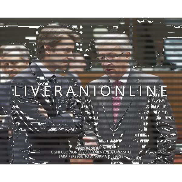(110712) Brussels, July 12, 2011 French Minister of Economy, Finance, \' Industry Francois Barouin (L) talks with the Luxembourg Prime Minister, President of the Eurogroup Jean-Claude Juncker (R) prior an EU EcoFin Ministers meeting.