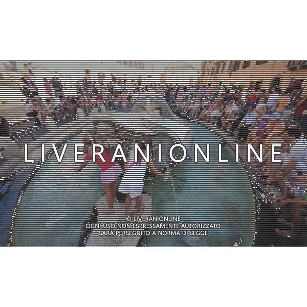 ROME, July 12, 2011 Girls play in the Fontana della Barcaccia in downtown Rome, capital of Italy, July 12, 2011. This year\'s 1st heat wave hit Italy recently, which stretched 13 cities including Rome to red alerts on Tuesday. (/Wang Qingqin) (yy)