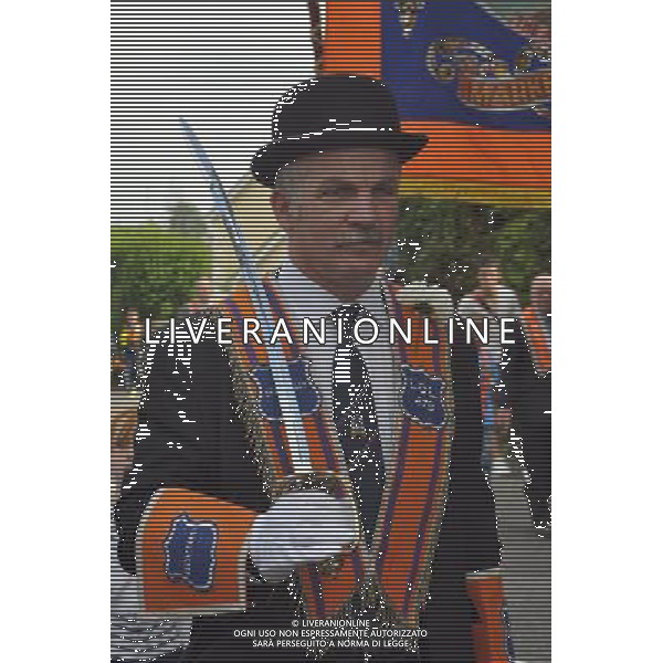 A member of the Orange Order, in traditional dress of Orange collar and bowler hat, on parade in 12th July celebrations in Killylea County Armagh Northern Ireland
