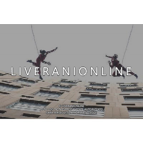 (110714) -- VANCOUVER, July 14, 2011 () -- Aeriosa Dance Society members perform at the walls of Vancouver Public Library during annual Dancing on the Edge festival in Vancouver, Canada, July 13, 2011. Aeriosa\'s artistic objectives include creating dance in non-traditional environments, exploring aerial choreography and revealing dance in the vertical realm to new audiences. Aeriosa combines contemporary dance technique with expert knowledge of safe rope rigging systems to create three-dimensional performances that re-interpret gravity and respond to the performance location. (/Sergei Bachlakov) (yc)