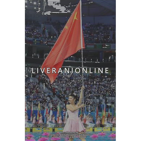 (110716) -- SHANGHAI, July 16, 2011 () -- A flag bearer carries China\'s national flag during the opening ceremony of the 14th FINA World Championships held in the Oriental Sports Center in Shanghai, east China, July 16, 2011.(/Fan Jun) (djj)