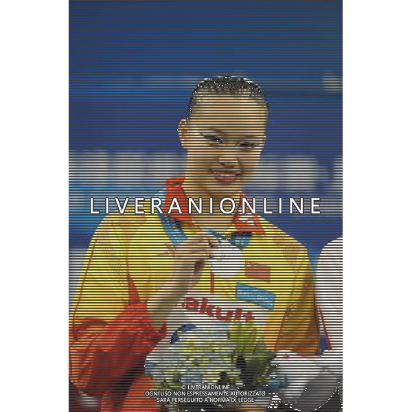(110717) -- SHANGHAI, July 17, 2011 () -- Huang Xuechen of China shows her silver medal at the awarding ceremony of the technical solo of synchronized swimming event at the 14th FINA World Championships in Shanghai, east China, July 17, 2011. Huang won the silver medal with 96.500 points. (/Yang Lei) (zgp)