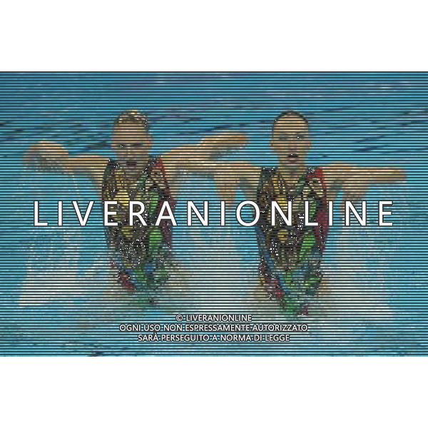 (110717) -- SHANGHAI, July 17, 2011 () -- Natalia Ishchenko/Svetlana Romashina of Russia compete in the preliminary round of the technical duets of synchronized swimming event at the 14th FINA World Championships in Shanghai, east China, July 17, 2011. They ranked first with 97.500 points in total in the preliminary round. (/Yang Lei)