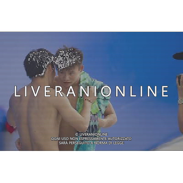 SHANGHAI, July 18, 2011 ()China\'s Li Shixin (L) talks with his teammate He Min after the final of the men\'s 1m springboard diving event at the 14th FINA World Championships in Shanghai, east China, July 18, 2011. Li Shixin claimed the title with 463.90 points. He Min won the silver medal with 444.00 points. (/Fei Maohua) (zgp)