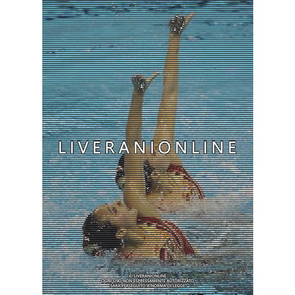 SHANGHAI, July 18, 2011 Huang Xuechen and Liu Ou (L) of China compete in the final of the technical duets of synchronized swimming event at the 14th FINA World Championships in Shanghai, east China, July 18, 2011. The Chinese duet grabbed the silver medal with 96.500 points. (/Ren Long) (zgp)