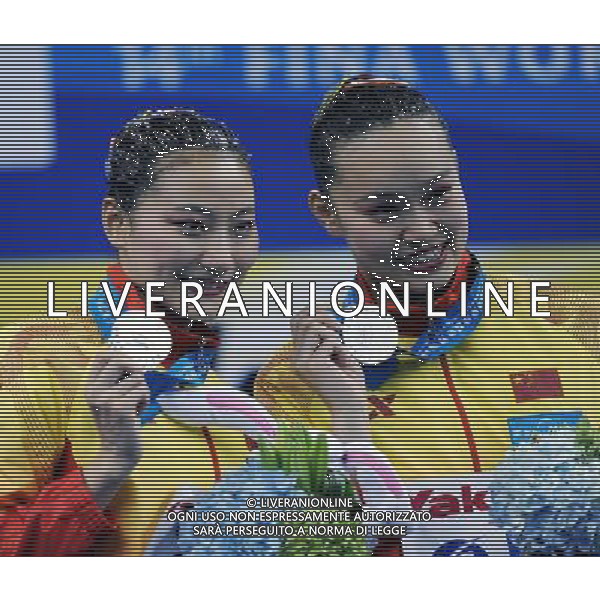 SHANGHAI, July 18, 2011 Huang Xuechen and Liu Ou (L) of China attend the awarding ceremony of the technical duets of synchronized swimming event at the 14th FINA World Championships in Shanghai, east China, July 18, 2011. The Chinese duet grabbed the silver medal with 96.500 points. (/Yang Zongyou) (zgp)