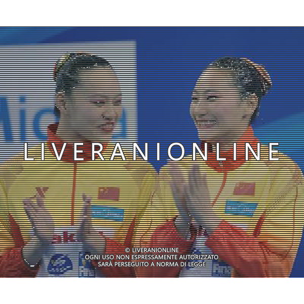SHANGHAI, July 18, 2011 Huang Xuechen and Liu Ou£®R) of China attend the awarding ceremony of the technical duets of synchronized swimming event at the 14th FINA World Championships in Shanghai, east China, July 18, 2011. The Chinese duet grabbed the silver medal with 96.500 points. (/Yang Zongyou) (zgp)