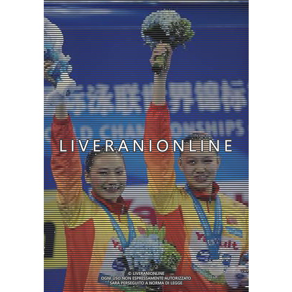 SHANGHAI, July 18, 2011 Huang Xuechen and Liu Ou (L) of China attend the awarding ceremony of the technical duets of synchronized swimming event at the 14th FINA World Championships in Shanghai, east China, July 18, 2011. The Chinese duet grabbed the silver medal with 96.500 points. (/Yang Zongyou) (zgp)