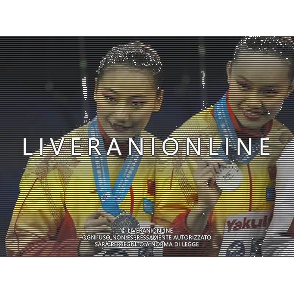 SHANGHAI, July 18, 2011 Huang Xuechen and Liu Ou (L) of China attend the awarding ceremony of the technical duets of synchronized swimming event at the 14th FINA World Championships in Shanghai, east China, July 18, 2011. The Chinese duet grabbed the silver medal with 96.500 points. (/Ren Long) (zgp)