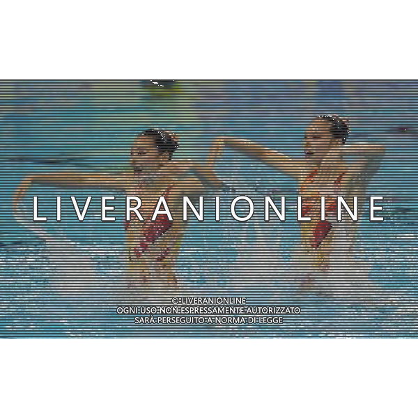 SHANGHAI, July 18, 2011 Huang Xuechen and Liu Ou (L) of China compete in the final of the technical duets of synchronized swimming event at the 14th FINA World Championships in Shanghai, east China, July 18, 2011. The Chinese duet grabbed the silver medal with 96.500 points. (/Wang Yuguo) (zgp)