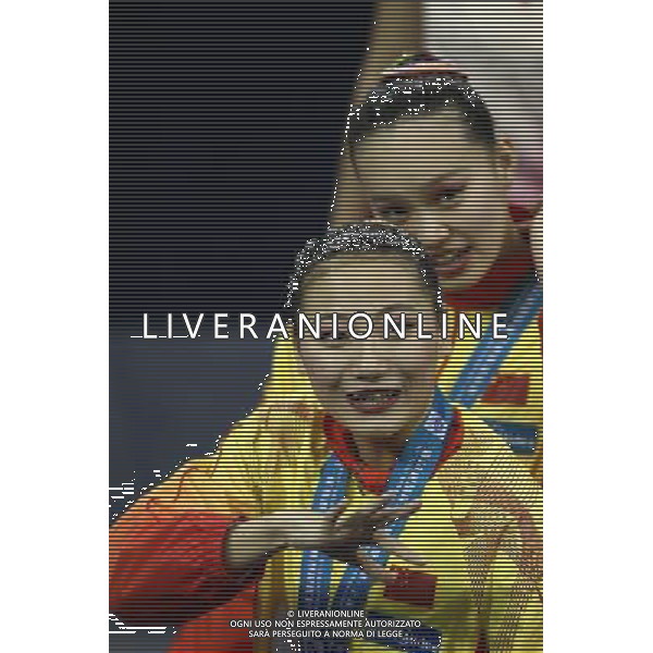 SHANGHAI, July 18, 2011 Huang Xuechen and Liu Ou (front) of China attend the awarding ceremony of the technical duets of synchronized swimming event at the 14th FINA World Championships in Shanghai, east China, July 18, 2011. The Chinese duet grabbed the silver medal with 96.500 points. (/Ren Long) (zgp)