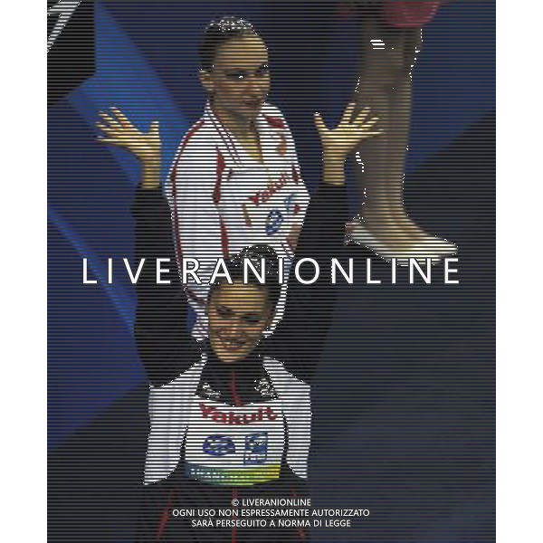 (110720) SHANGHAI, July 20, 2011 () Andrea Fuentes of Spain (bottom) waves to spectators at the awarding ceremony of the solo free synchronized swimming competition at the 14th FINA World Championships in Shanghai, east China, July 20, 2011. Andrea Fuentes won the silver medal with 96.520 points. (/Guo Yong)