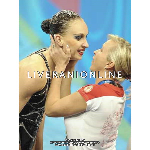 (110720) SHANGHAI, July 20, 2011 () Natalia Ishchenko (L) of Russia celebrates with her coach after the final of the solo free synchronized swimming competition at the 14th FINA World Championships in Shanghai, east China, July 20, 2011. Natalia Ishchenko claimed the title with 98.550 points. (/Yang Zongyou) (zgp)