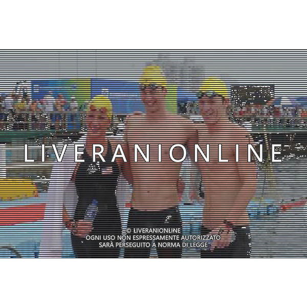 (110721) -- SHANGHAI, July 21, 2011 () -- Andrew Gemmell (R), Ashley Grace Twichell (L), and Sean Ryan of the United States pose for a group photo after the open water 5km team event at the 14th FINA World Championships in Shanghai, east China, July 21, 2011. The U.S. team claimed the title with 57:00.6. (/Guo Yong) (zgp)