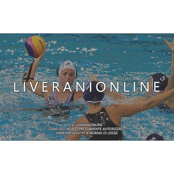 (110721) -- SHANGHAI, July 21, 2011 () -- Lauren Jane Sieprath (back) of New Zealand shoots in the preliminary round of women\'s water polo event between Canada and New Zealand at the 14th FINA World Championships in Shanghai, east China, July 21, 2011. Canada won the match 11-4. (/Pei Xin) (sqq)