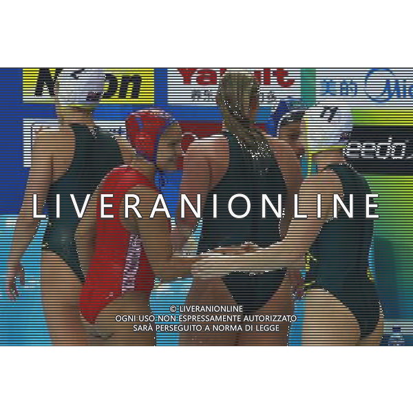 (110721) -- SHANGHAI, July 21, 2011 () -- Elena Dukhanova (L, front) of Uzbekistan shakes hands with Melissa Alison Rippon of Australia (R) after competing in the preliminary round of women\'s water polo event at the 14th FINA World Championships in Shanghai, east China, July 21, 2011. Australia won the match 27-2. (/Pei Xin) (sqq)