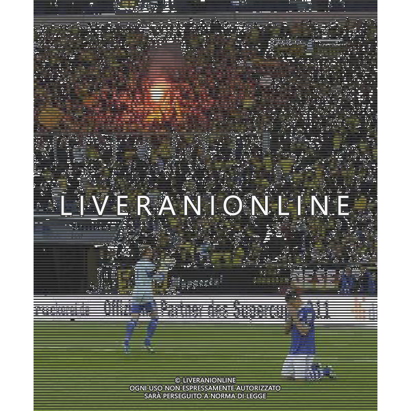 firo : Fußball,Fussball, 23.07.2011 1.BL, 1.Bundesliga, Saison 2011/2012 Supercup 2011, FC SCHALKE 04 - BVB, Borussia Dortmund 4:3 n.E. Fans BVB, PAPADOPOULOS betet, bengalische Feuer $worldrightsEs gelten unsere AGB, einsehbar auf www.firosportphoto.de copyright by firo sportphoto: Pfefferackerstr. 2a  45894 G e l s e n k i r c h e n www.firosportphoto.de mail@firosportphoto.de (V o l k s b a n k B o c h u m - W i t t e n ) BLZ.: 430 601 29 Kt. Nr.: 341 117 100 Tel:  0209 - 9304402 Fax:  0209 - 9304443
