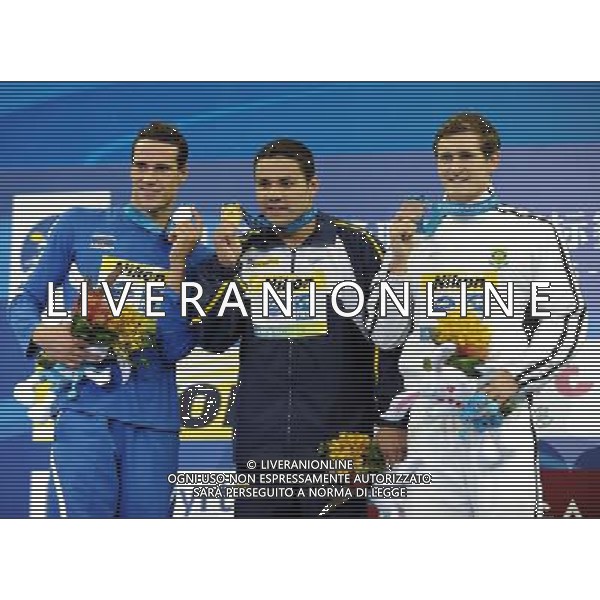 (110727) -- SHANGHAI, July 27, 2011 () -- Felipe Alves Franca Da Silva (C) of Brazil, Fabio Scozzoli (L) of Italy, Cameron Van Der Burgh of South Africa pose in the awarding ceremony of men\'s 50m breaststroke swimming event at the 14th FINA World Championships in Shanghai, east China, July 27, 2011. Felipe Alves Franca Da Silva claimed the title with 27.01. Fabio Scozzoli won the silver medal with 27.17. Cameron Van Der Burgh got the bronze medal with 27.19. (/Guo Yong) (sqq)