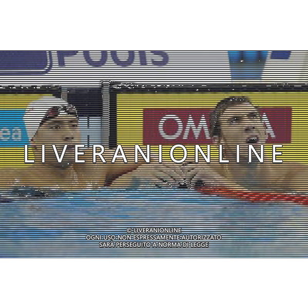 (110727) -- SHANGHAI, July 27, 2011 () -- Michael Phelps of the United States (R) and Wu Peng of China react after the final of men\'s 200m butterfly swimming event at the 14th FINA World Championships in Shanghai, east China, July 27, 2011. Michael Phelps claimed the title with 1:53.34. Wu Peng of China won the bronze medal with 1:54.67. (/Fan Jun) (zgp)