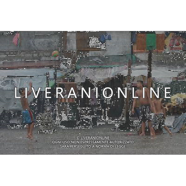 (110727) -- MANILA, July 27, 2011 () -- Children play in the rain as classes were suspended due to tropical storm Nock-ten in Manila, the Philippines, on July 27, 2011. The country\'s National Disaster Risk Reduction and Management Council said the death toll rose to at least 14 due to rains and floods brought by tropical storm Nock-Ten. (/Rouelle Umali) (jy)