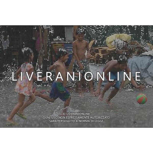 (110727) -- MANILA, July 27, 2011 () -- Children play in the rain as classes were suspended due to tropical storm Nock-ten in Manila, the Philippines, on July 27, 2011. The country\'s National Disaster Risk Reduction and Management Council said the death toll rose to at least 14 due to rains and floods brought by tropical storm Nock-Ten. (/Rouelle Umali) (jy)