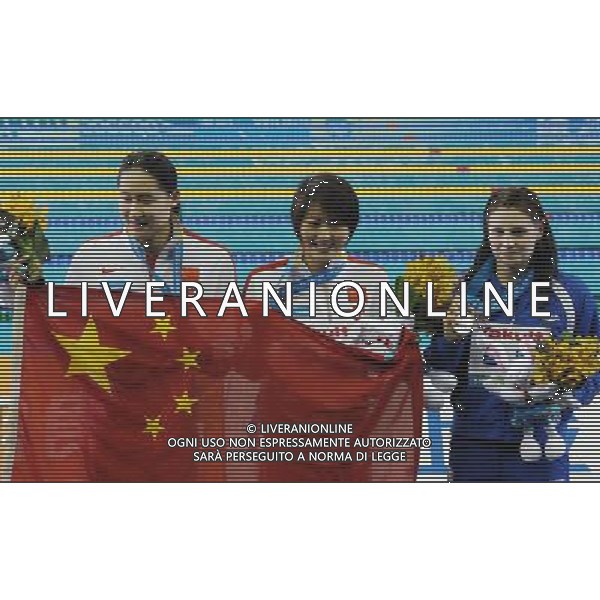 (110728) -- SHANGHAI, July 28, 2011 () -- Jiao Liuyang (C) and Liu Zige (L) of China, Ellen Gandy of Britain pose in the awarding ceremony of women\'s 200m butterfly swimming event at the 14th FINA World Championships in Shanghai, east China, July 28, 2011. Jiao Liuyang of China claimed the title with 2:05.55. Ellen Gandy won the silver medal with 2:05.59. Liu Zige got the bronze medal with 2:05.90. (/Yang Lei) (zgp)