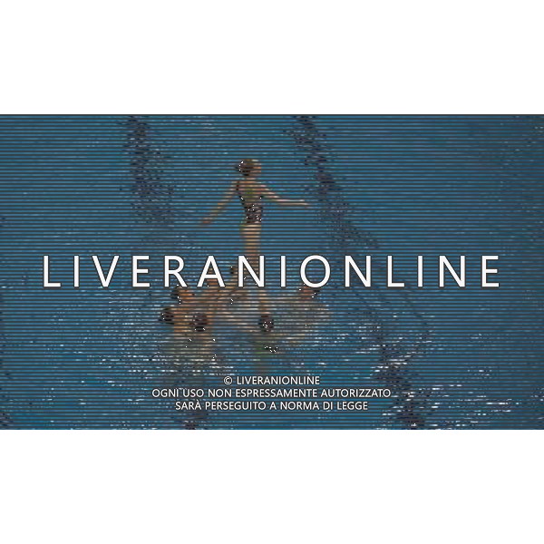 A synchronised swimming team perform in the Diving pool