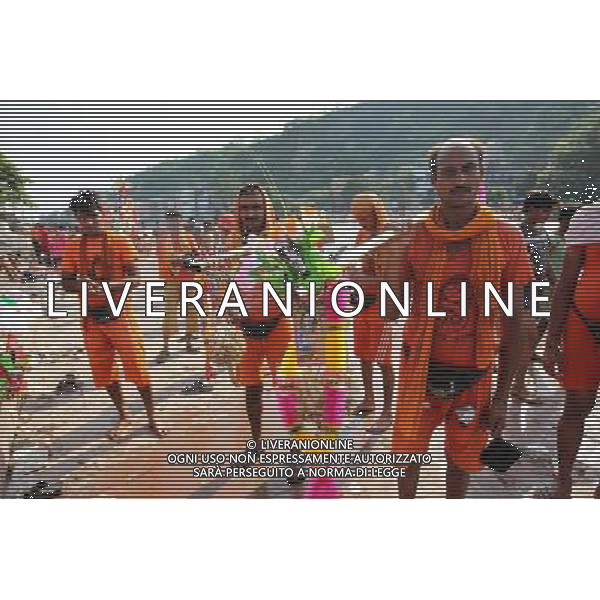 (110728) -- NEW DELHI, July 28, 2011 () -- Devotees of Hinduism carry holy water in Haridwar, Uttaranchal State of India, on July 27, 2011. Hindu pilgrims, also known as \'Kanwarias\', arrive barefoot from across the country and converge on the banks of the River Ganges annually to collect holy water (kanwar) from the River Ganges in Haridwar, Gangotri or Gaumukh in the northern Indian state of Uttaranchal, then pour the holy water in their hometown temples. This journey, completed on foot, is supposed to fulfil their wishes and endear them to Lord Shiva, the Hindu God of Destruction. All along the route to Haridwar, voluntary organizations put up food and medical stalls to cater to the pilgrims. (/Li Yigang) (lb)