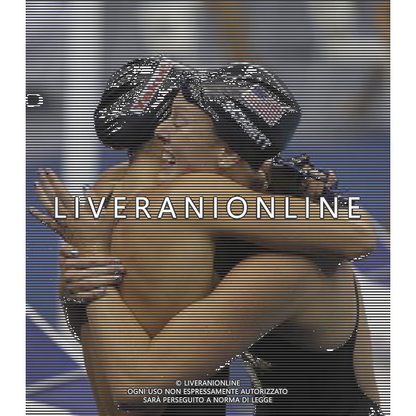 (110728) -- SHANGHAI, July 28, 2011 () -- Allison Schmitt of the United States (R) hugs with a teammate after the final of women\'s 4x200m freestyle swimming event at the 14th FINA World Championships in Shanghai, east China, July 28, 2011. The team of the United States claimed the title with 7:46.14. (/Fei Maohua)
