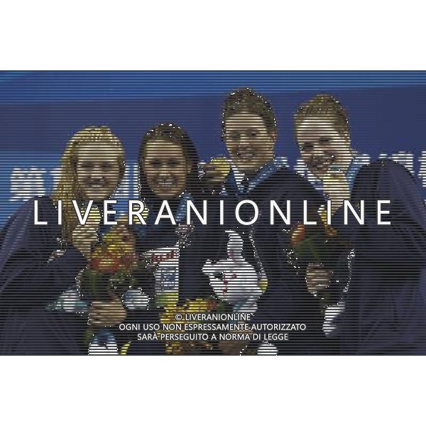 (110728) -- SHANGHAI, July 28, 2011 () -- Swimmers of the United States pose in the awarding ceremony of women\'s 4x200m freestyle swimming event at the 14th FINA World Championships in Shanghai, east China, July 28, 2011. The team of the United States claimed the title with 7:46.14. (/Ren Long) (sqq)