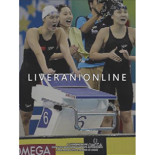 (110728) -- SHANGHAI, July 28, 2011 () -- Pang Jiaying, Chen Qian, and Liu Jing (from L to R) of China cheer for their teammate Tang Yi in the final of women\'s 4x200m freestyle swimming event at the 14th FINA World Championships in Shanghai, east China, July 28, 2011. The team of China won the bronze medal with 7:47.66. (/Fan Jun) (zgp)