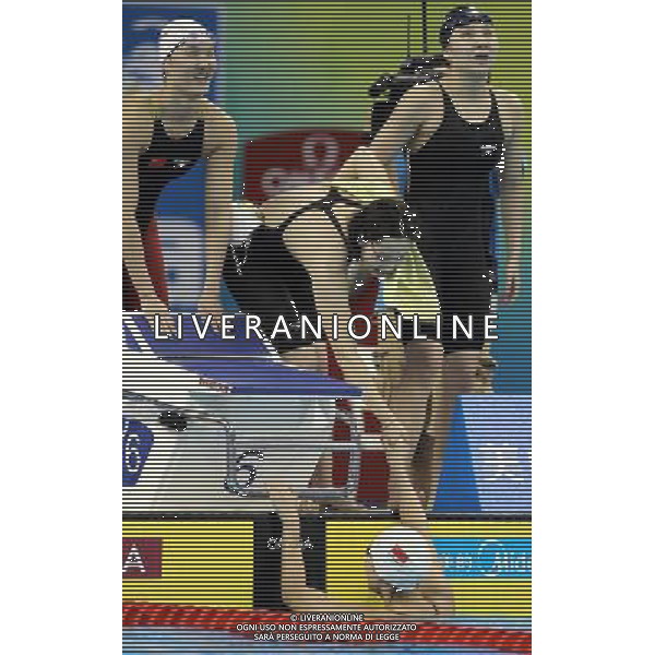 (110728) -- SHANGHAI, July 28, 2011 () -- Pang Jiaying, Chen Qian, Liu Jing (from L to R), and Tang Yi (bottom) of China react after the final of women\'s 4x200m freestyle swimming event at the 14th FINA World Championships in Shanghai, east China, July 28, 2011. The team of China won the bronze medal with 7:47.66. (/Fan Jun) (zgp)