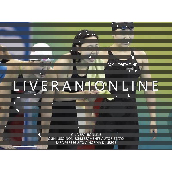 (110728) -- SHANGHAI, July 28, 2011 () -- Pang Jiaying, Chen Qian, and Liu Jing (from L to R) of China cheer for their teammate Tang Yi in the final of women\'s 4x200m freestyle swimming event at the 14th FINA World Championships in Shanghai, east China, July 28, 2011. The team of China won the bronze medal with 7:47.66. (/Fan Jun) (zgp)