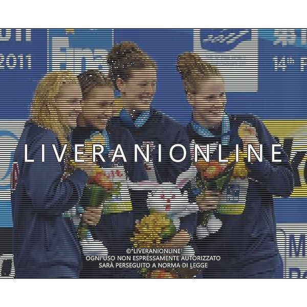 (110728) -- SHANGHAI, July 28, 2011 () -- Swimmers of the United States pose in the awarding ceremony of women\'s 4x200m freestyle swimming event at the 14th FINA World Championships in Shanghai, east China, July 28, 2011. The team of the United States claimed the title with 7:46.14. (/Yang Lei) (sqq)