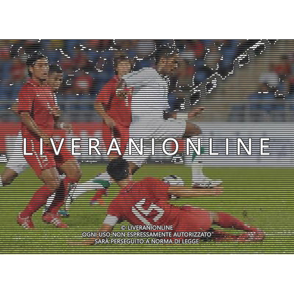 (110728) -- HONG KONG, July 28, 2011 () -- Chan Wai Ho (Bottom) of Hong Kong of China vies with Nawaf Shaker Alabid (Top) of Saudi Arabia during their second round of Asian qualifier match for the 2014 World Cup in Hong Kong, south China, July 28, 2011. Saudi Arabia defeated Hong Kong by 5-0. (/Lo Ping Fai)