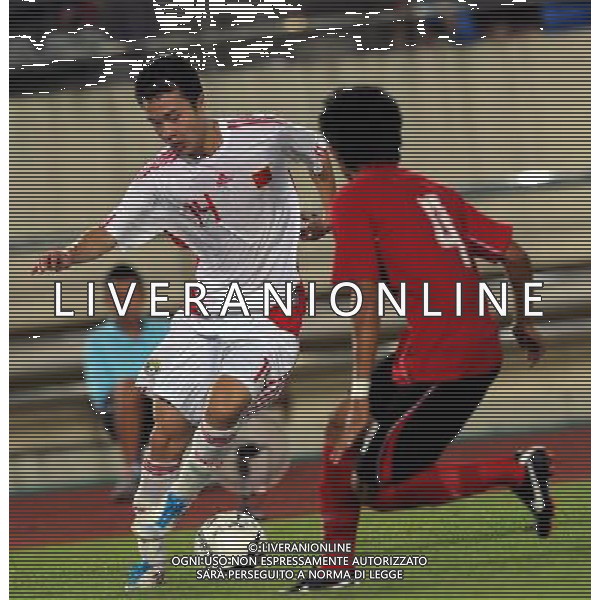 (110728) -- VIENTIANE, July 28, 2011 () -- Feng Renliang (L) of China vies for the ball against Souksavanh of Laos during their qualifier match of the 2014 FIFA World Cup Brazil in Vientiane, capital of Laos, July 28, 2011. China won 6-1. (/Chen Xiaowei)