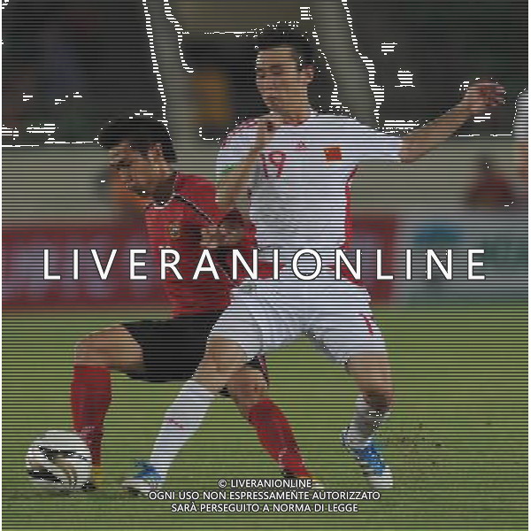 (110728) -- VIENTIANE, July 28, 2011 () -- Yang Hao (R) of China vies for the ball against Sysomavang of Laos during their qualifier match of the 2014 FIFA World Cup Brazil in Vientiane, capital of Laos, July 28, 2011. China won 6-1. (/Chen Xiaowei)