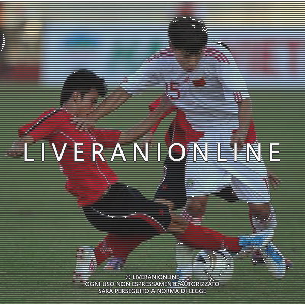 (110728) -- VIENTIANE, July 28, 2011 () -- Yu Hanchao (Top) of China tries to break through players of Laos during their qualifier match of the 2014 FIFA World Cup Brazil in Vientiane, capital of Laos, July 28, 2011. China won 6-1. (/Chen Xiaowei)