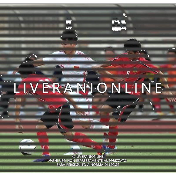 (110728) -- VIENTIANE, July 28, 2011 () -- Yu Hanchao (C) of China vies for the ball against Inthammavong (R) of Laos during their qualifying match of the 2014 FIFA World Cup Brazil in Vientiane, capital of Laos, July 28, 2011. (/Chen Xiaowei)