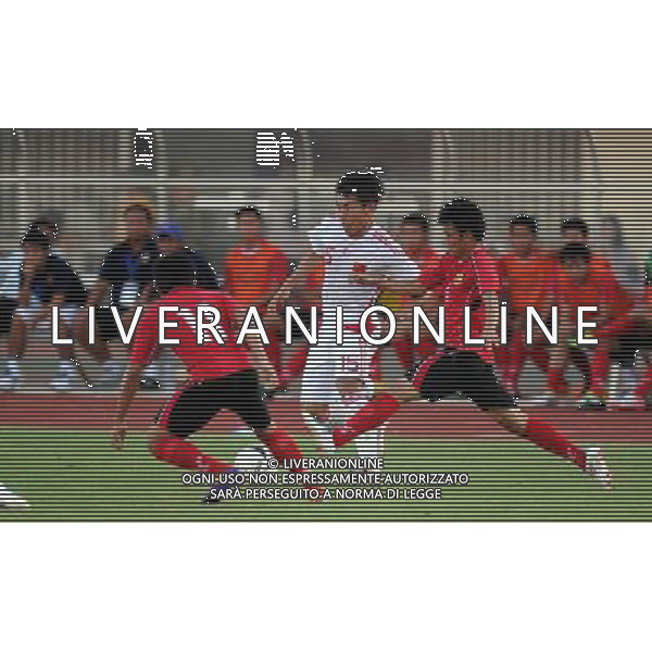 (110728) -- VIENTIANE, July 28, 2011 () -- Yu Hanchao (C) of China vies for the ball against Inthammavong (R) of Laos during their qualifying match of the 2014 FIFA World Cup Brazil in Vientiane, capital of Laos, July 28, 2011. (/Chen Xiaowei)