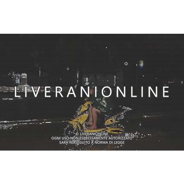 (110729) -- WENCHANG, July 29, 2011 () -- A local resident rides an autocycle in the rain caused by Nock-Ten in Wenchang City, south China\'s Hainan Province, July 29, 2011. Tropical storm Nock-Ten landed in coastal areas of Hainan Province on Friday afternoon. (/Wang Huiyu) (gsy)